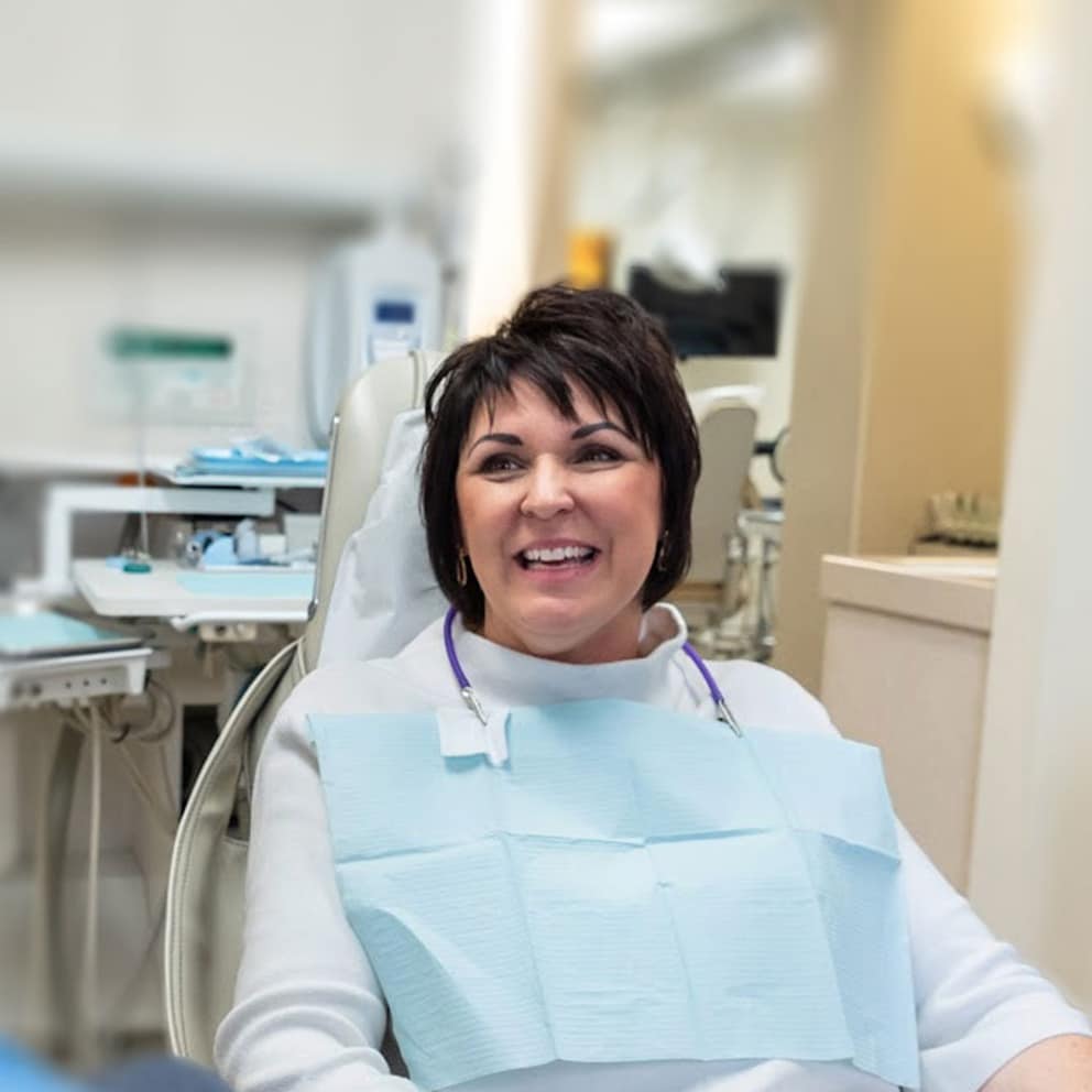 Patient smiling during a consultation for dental implants at Knight Dental Care in Michigan